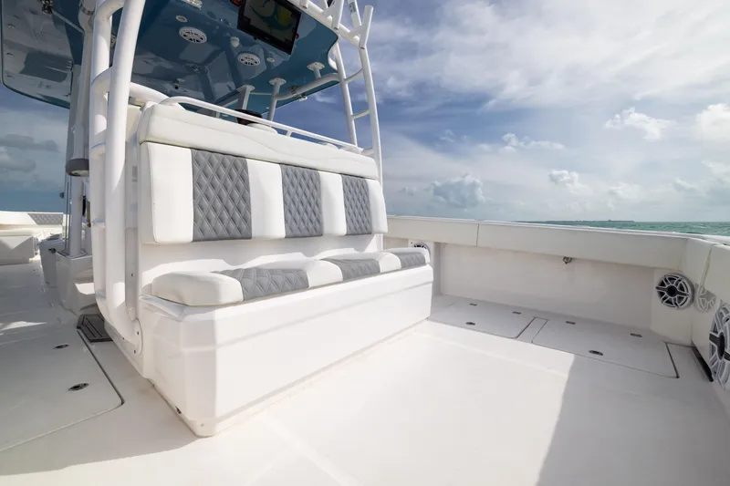Slide: The Image of 2023 Invincible 37 Catamaran interior with cushioned seating and ocean view. - 32