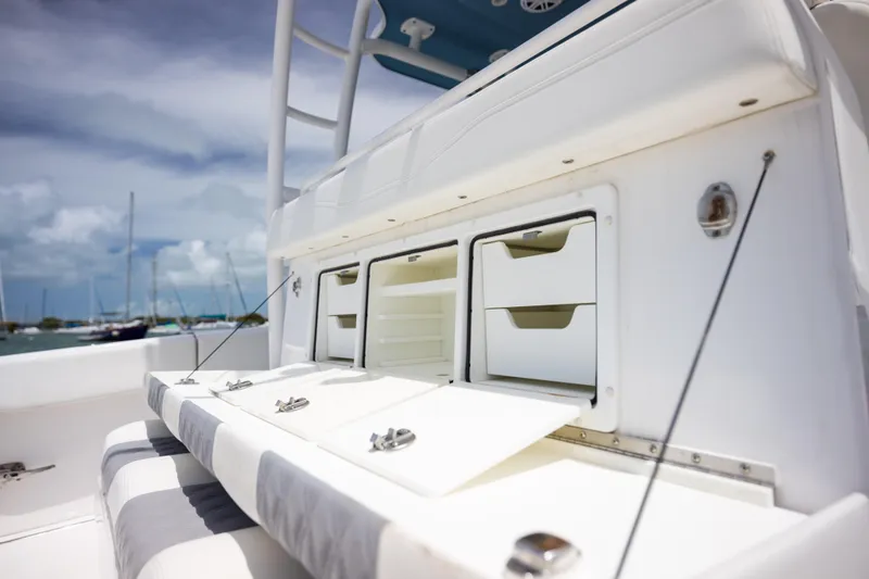 Slide: The Image of 2023 Invincible 37 Catamaran interior storage compartments with open hatches, showcasing sleek design. - 33