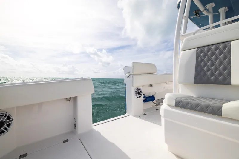 Slide: The Image of 2023 Invincible 37 Catamaran interior with ocean view, featuring cushioned seating. - 34