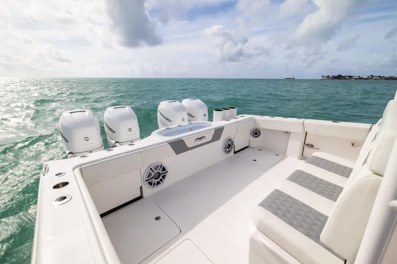 Slide: The Image of 2023 Invincible 37 Catamaran on open sea, featuring spacious deck and powerful engines. - 35