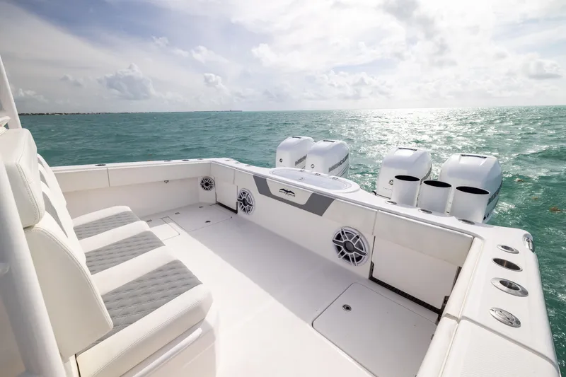 Slide: The Image of 2023 Invincible 37 Catamaran on open sea, showcasing spacious deck and powerful engines. - 36