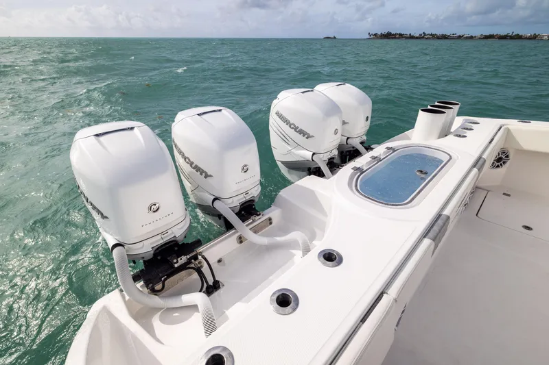 Slide: The Image of 2023 Invincible 37 Catamaran with four Mercury outboard engines on open water. - 39