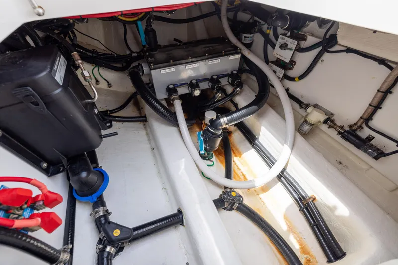 Slide: The Image of Engine compartment of 2023 Invincible 37 Catamaran, showcasing hoses and mechanical components. - 40