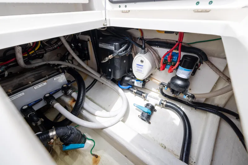 Slide: The Image of Engine compartment of 2023 Invincible 37 Catamaran, showcasing intricate wiring and plumbing systems. - 41