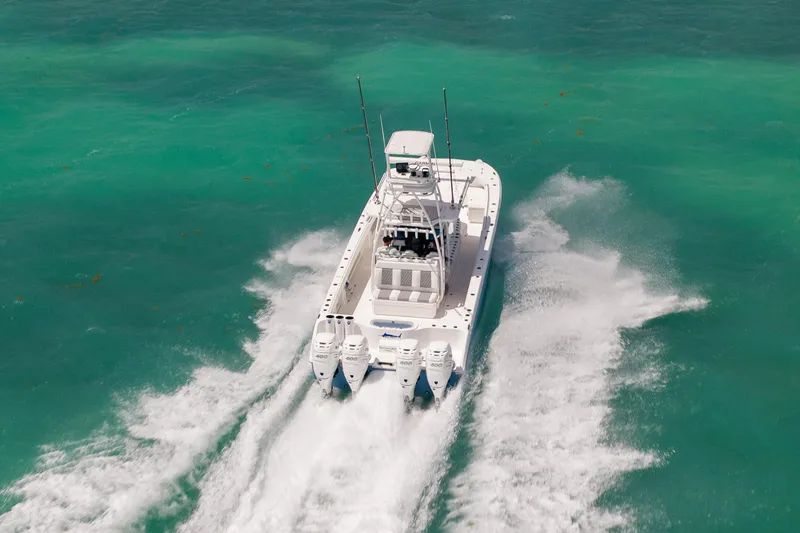 Slide: The Image of 2023 Invincible 37 Catamaran cruising on turquoise waters, showcasing powerful engines. - 6