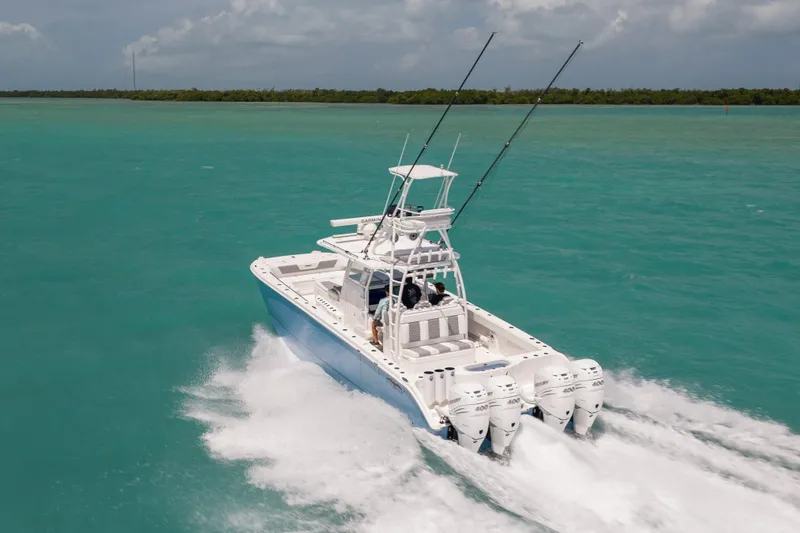 Slide: The Image of 2023 Invincible 37 Catamaran cruising on turquoise waters with powerful engines. - 7