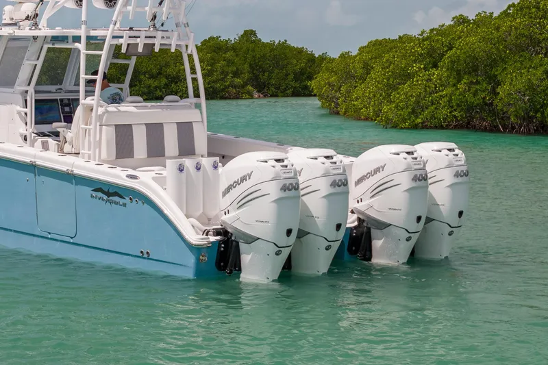 Slide: The Image of 2023 Invincible 37 Catamaran with four Mercury 400 engines in turquoise waters. - 9