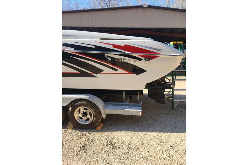 Slide: The Image of 2008 Formula 353 FASTech boat on trailer, featuring sleek red and black graphics. - 15