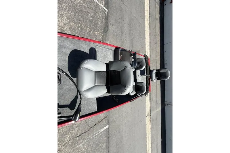 Slide: The Image of 2026 Tracker Bass Tracker Classic XL boat interior with gray seating and red trim. - 10