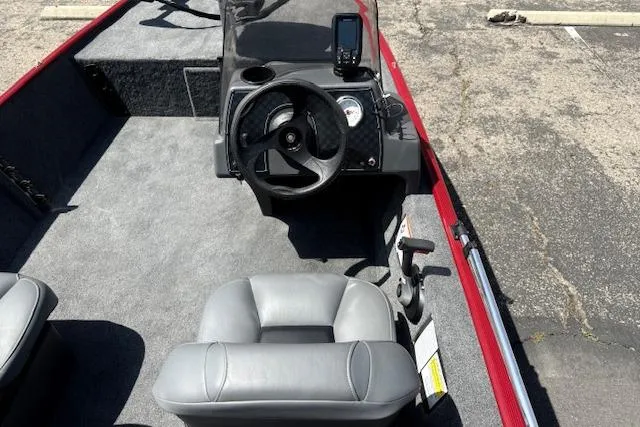 Slide: The Image of 2026 Tracker Bass Tracker Classic XL boat interior with steering wheel and seating. - 14