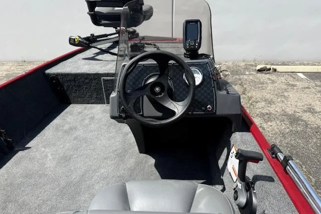 Slide: The Image of 2026 Tracker Bass Tracker Classic XL boat interior with steering wheel and navigation equipment. - 16