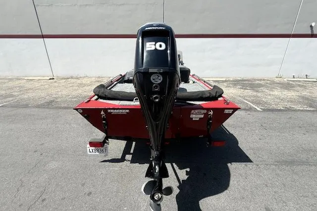 Slide: The Image of 2026 Tracker Bass Tracker Classic XL boat with Mercury 50 engine, parked outdoors. - 17