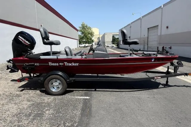 Slide: The Image of 2026 Tracker Bass Tracker Classic XL boat on trailer, parked outdoors. - 18