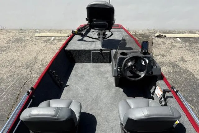 Slide: The Image of 2026 Tracker Bass Tracker Classic XL boat interior with steering wheel and seating. - 19