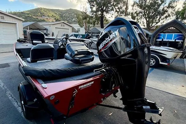 Slide: The Image of 2026 Tracker Bass Tracker Classic XL boat with Mercury engine in a scenic outdoor setting. - 2