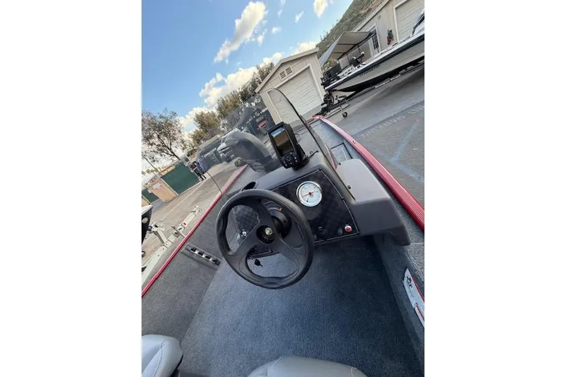 Slide: The Image of 2026 Tracker Bass Tracker Classic XL boat dashboard with steering wheel and gauges. - 4