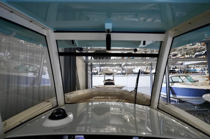 Slide: The Image of 2019 Cobia 344 Center Console boat in storage facility, surrounded by other boats. - 15