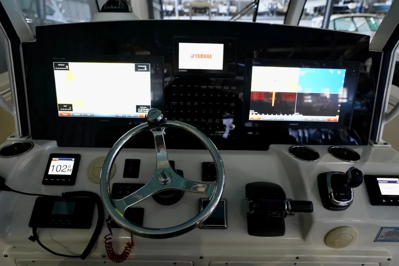 Slide: The Image of 2019 Cobia 344 Center Console dashboard with advanced navigation displays and controls. - 20