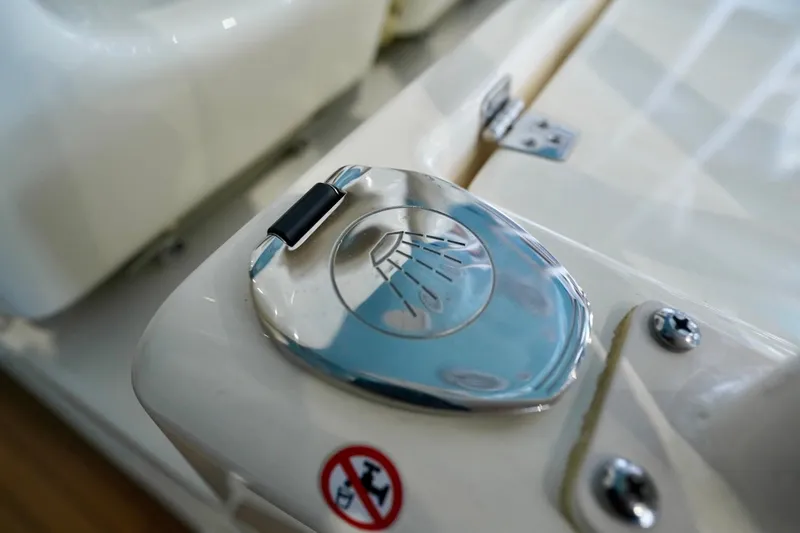 Slide: The Image of Close-up of a 2019 Cobia 344 Center Console boat's chrome shower cover. - 24