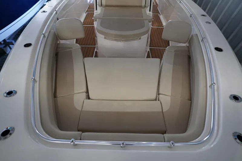 Slide: The Image of 2019 Cobia 344 Center Console boat interior with cushioned seating and wood flooring. - 26