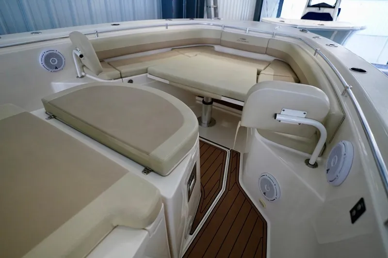 Slide: The Image of 2019 Cobia 344 Center Console boat interior with cushioned seating and wood flooring. - 28