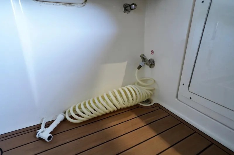Slide: The Image of Coiled hose on 2019 Cobia 344 Center Console boat deck. - 32