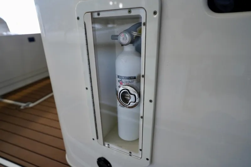 Slide: The Image of Fire extinguisher compartment on 2019 Cobia 344 Center Console boat. - 34