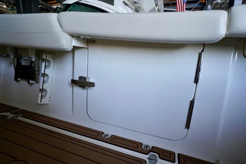 Slide: The Image of 2019 Cobia 344 Center Console boat interior with white seating and storage compartment. - 35