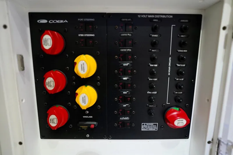 Slide: The Image of Control panel of a 2019 Cobia 344 Center Console boat with switches and dials. - 36