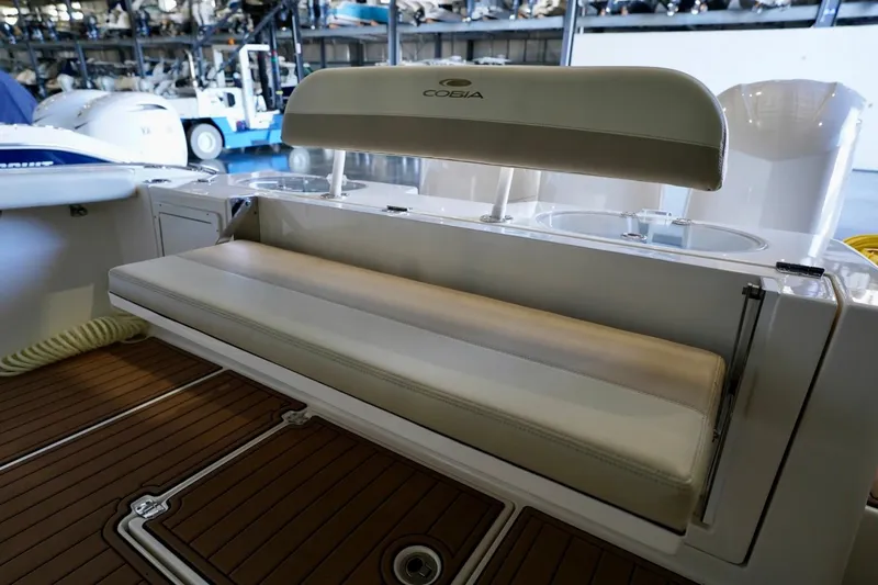 Slide: The Image of 2019 Cobia 344 Center Console boat interior with cushioned seating and wooden deck. - 7