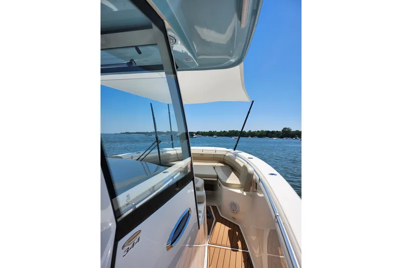 Slide: The Image of 2019 Cobia 344 Center Console boat on water, showcasing sleek design and spacious deck. - 24