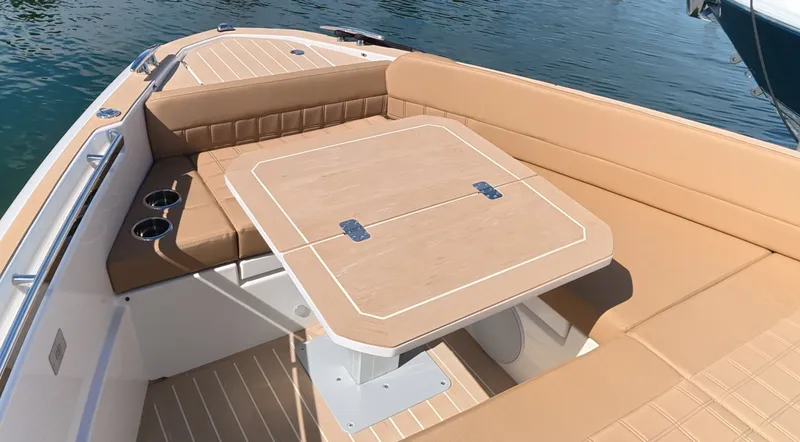 Slide: The Image of The image shows the bow area of a Saxdor 400 GTS with a sleek wooden table and beige upholstery. - 37