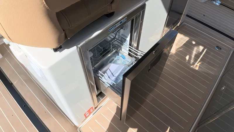 Slide: The Image of An open refrigerator on a boat with wooden flooring. - 18