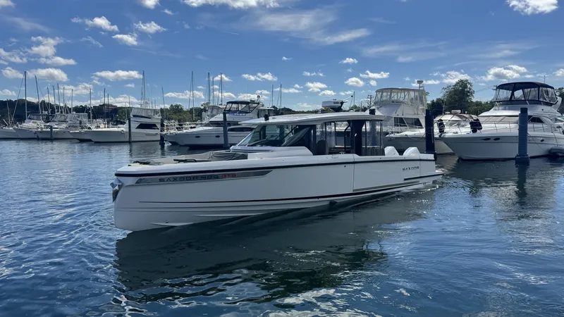 Slide: The Image of A 2027 Saxdor 400 GTS is in the water, surrounded by other boats in the marina. - 40