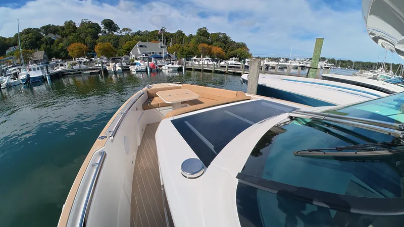 Slide: The Image of The image shows a modern boat docked in a marina. It features a sleek design with a spacious deck. - 35