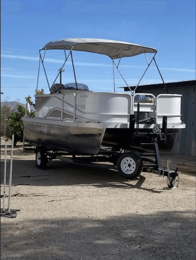 Slide: The Image of 2019 SunCatcher 18F Pontoon parked outdoors on a trailer. - 2