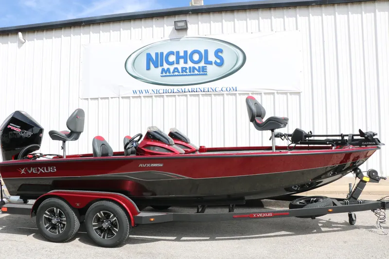 Slide: The Image of 2026 Vexus AVX 1985s boat displayed at Nichols Marine dealership. - 2