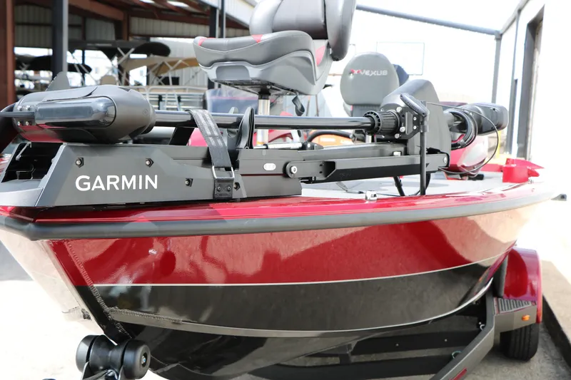 Slide: The Image of 2026 Vexus AVX 1985s boat with Garmin equipment, red and black design. - 21