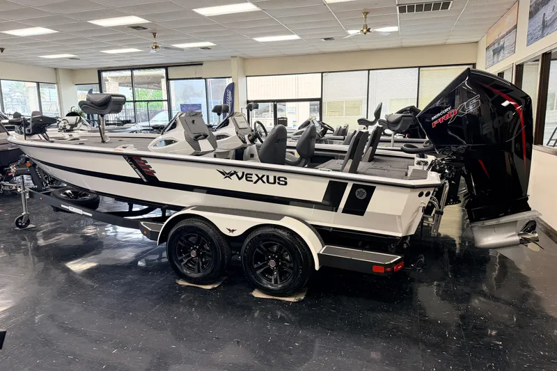 The Image of 2026 Vexus AVX 1985s boat displayed indoors with Mercury Pro XS engine. - 0