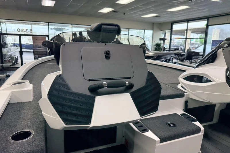 Slide: The Image of 2026 Vexus AVX 1985s boat interior with modern dashboard and seating in showroom. - 13