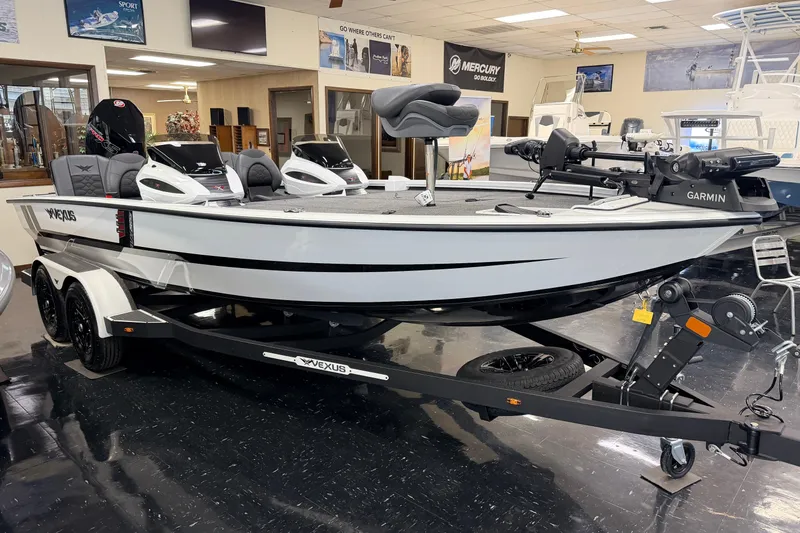 Slide: The Image of 2026 Vexus AVX 1985s boat in showroom, featuring sleek design and advanced Garmin equipment. - 2