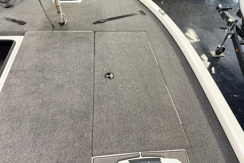 Slide: The Image of 2026 Vexus AVX 1985s boat deck with gray carpet and storage compartment. - 23