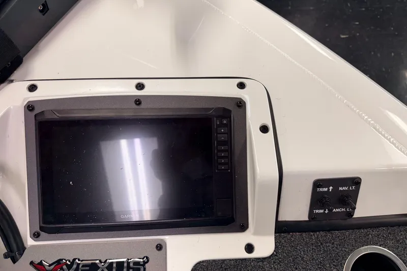 Slide: The Image of 2026 Vexus AVX 1985s boat dashboard with Garmin display and control switches. - 27