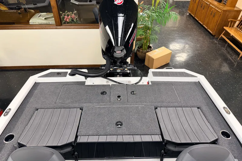 Slide: The Image of 2026 Vexus AVX 1985s boat interior with motor, gray seating, and storage compartments. - 32