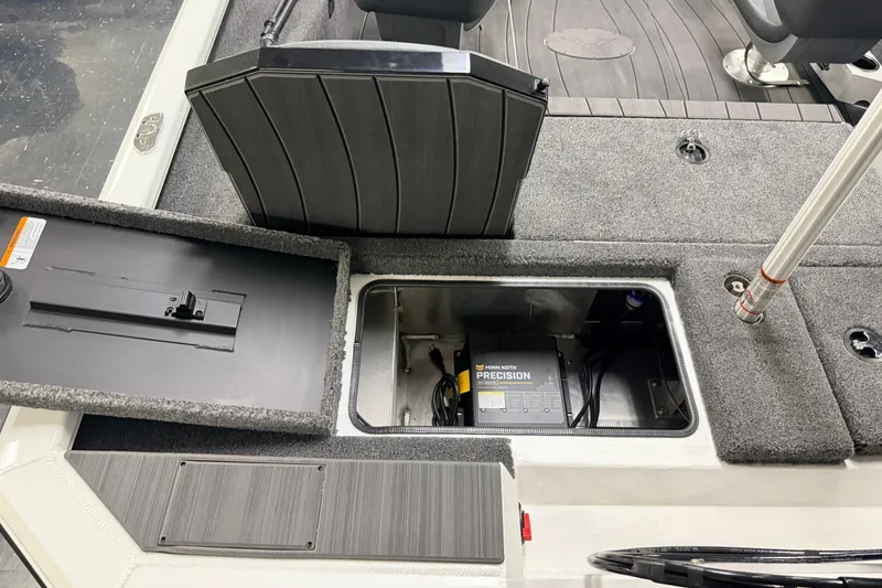 Slide: The Image of 2026 Vexus AVX 1985s boat interior with open storage compartment and Minn Kota Precision charger. - 38