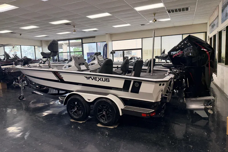 Slide: The Image of 2026 Vexus AVX 1985s boat displayed indoors, featuring sleek design and powerful engine. - 45