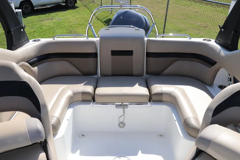 Slide: The Image of 2016 Hurricane SunDeck 2486 OB boat interior with beige seating and spacious layout. - 14