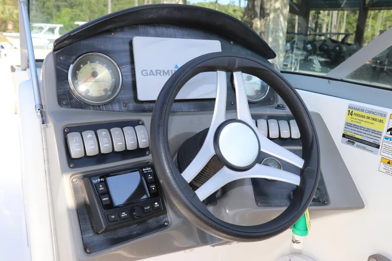 Slide: The Image of Steering console of 2016 Hurricane SunDeck 2486 OB with Garmin display and controls. - 15