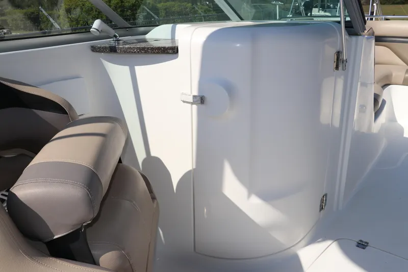 Slide: The Image of 2016 Hurricane SunDeck 2486 OB interior with seating and storage compartment. - 16