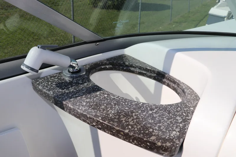 Slide: The Image of 2016 Hurricane SunDeck 2486 OB boat sink with speckled countertop and faucet. - 17
